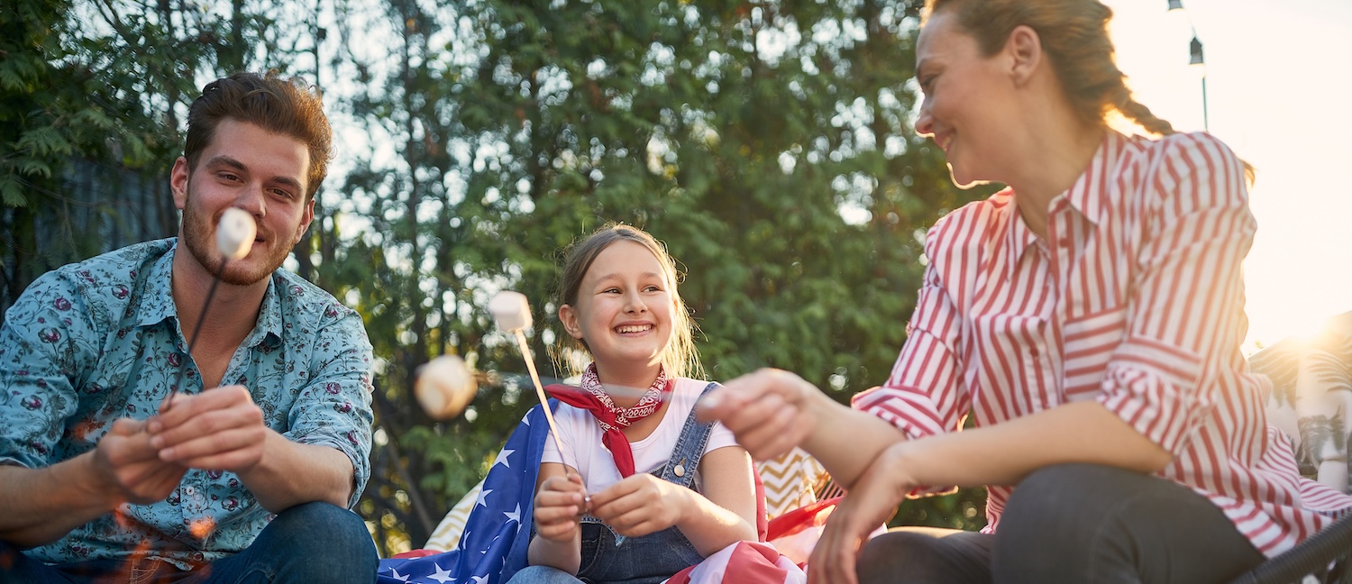 family roasting marshmallows for the 4th of July